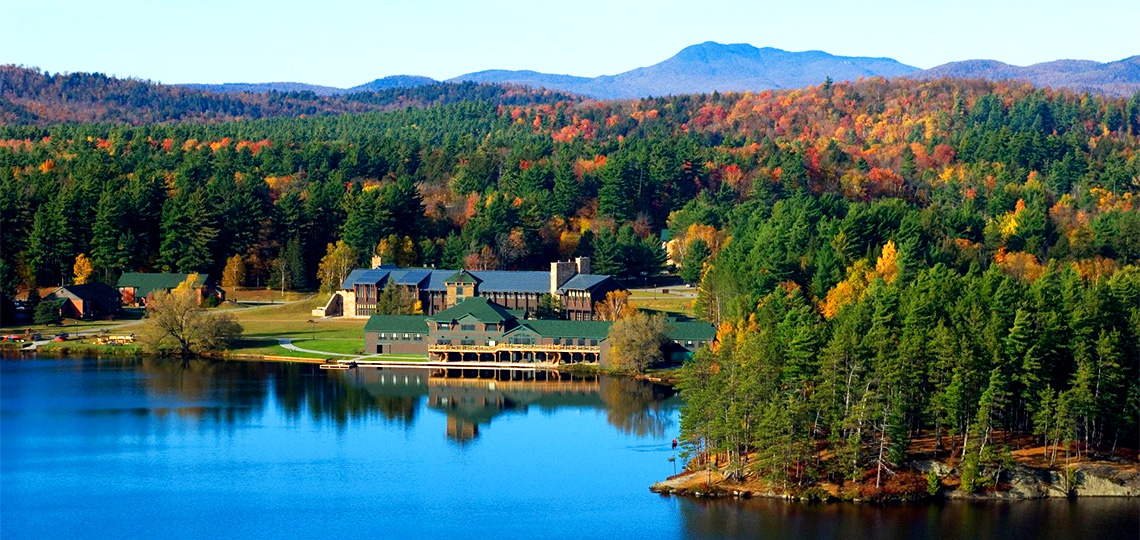 Paul Smith's College lakeside campus surrounded by trees in the Adirondacks