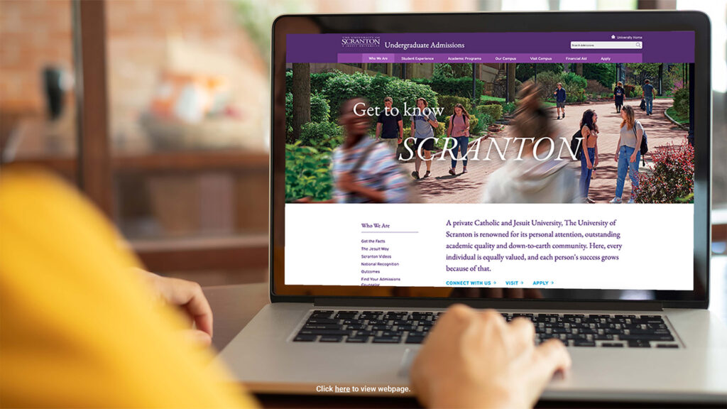 A laptop screen displaying The University of Scranton Undergraduate Admissions website with students walking on campus — example of a responsive college admissions webpage design.